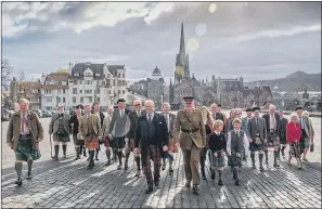  ??  ?? CLAN DO ATTITUDE: Clansmen and clanswomen march to the Great Hall at Edinburgh Castle.