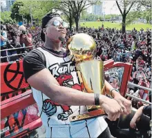  ?? FRANK GUNN THE CANADIAN PRESS FILE PHOTO ?? Raptors guard Kyle Lowry holds the Larry O’Brien Championsh­ip Trophy as he celebrates the team’s NBA victory at a June 17 parade in Toronto.