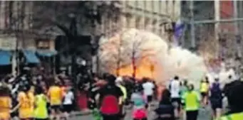 ?? WBZTV/ THE ASSOCIATED PRESS ?? In this image from video provided by WBZ TV, spectators and runners run from what was described as twin explosions that shook the finish line of the Boston Marathon, Monday, just as many runners were returning.