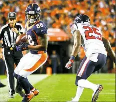  ?? Dustin Bradford/Getty Images ?? Demaryius Thomas of the Denver Broncos, left, catches a pass for 8 yards and a first down Monday night against the Texans in Denver.