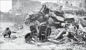  ??  ?? (Photos above, right and bottom) Volunteers salvaging and cleaning up the debris and destructio­n in the Bab al-Saray area in the old city of the northern Iraqi city of Mosul.