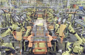  ?? — Reuters ?? Robotic arms spot welds on the chassis of a Ford Transit Van under assembly at the Ford Claycomo Assembly Plant in Claycomo, US.