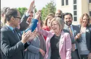  ?? JASON FRANSON/THE CANADIAN PRESS ?? Alberta Premier Rachel Notley celebrates the pipeline decision Tuesday with members of her NDP caucus.