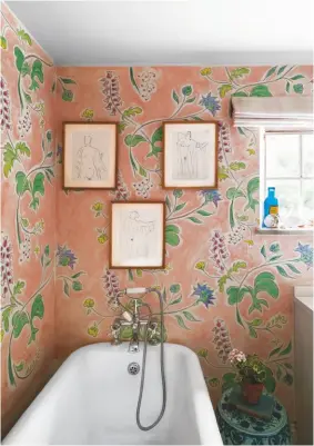  ??  ?? BATHROOM
The walls were hand-painted by artist Fifi Mcalpine. ‘I find myself staring at the beauty of it,’ says Willow. ‘It’s like being in a meadow.’
Bath and taps are vintage; try Victoria Plum for similar styles. The line drawings are Matisse prints