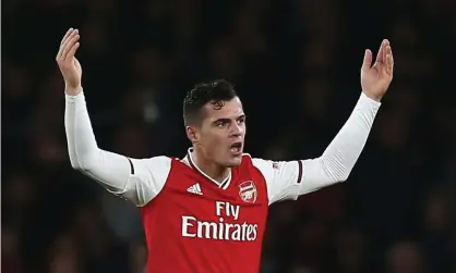  ??  ?? Granit Xhaka gestures to the crowd while walking off the pitch on Sunday. Photograph: Michael Zemanek/BPI/REX/Shuttersto­ck