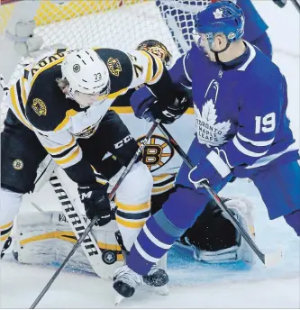  ?? RICK MADONIK TORONTO STAR ?? Boston goaltender Tuukka Rask finds the puck with his pad in the confusion behind Bruins defenceman Charlie McAvoy and Toronto Maple Leafs centre Tomas Plekanec (19) in the slot during Game 3 of their Eastern Conference playoff series Wednesday night...