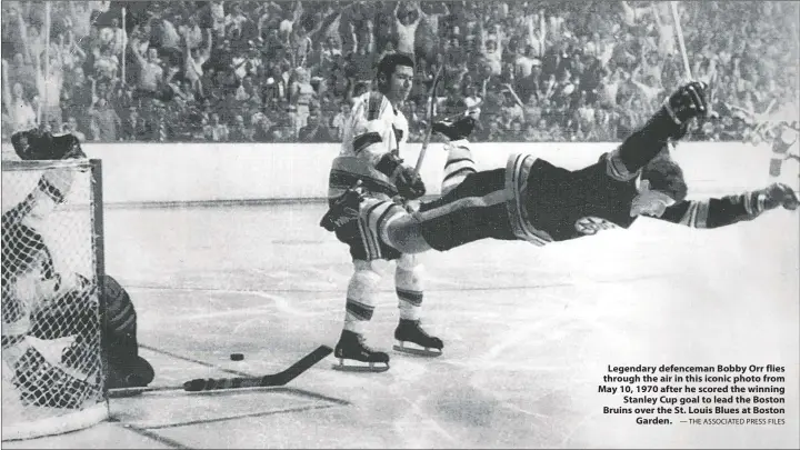  ?? — THE ASSOCIATED PRESS FILES ?? Legendary defenceman Bobby Orr flies through the air in this iconic photo from May 10, 1970 after he scored the winning Stanley Cup goal to lead the Boston Bruins over the St. Louis Blues at Boston Garden.