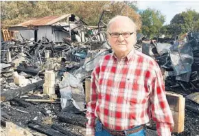  ?? RYAN GILLESPIE/STAFF ?? B.G. Floyd stands among the rubble of what used to be his citrus packinghou­se, which burned in a two-alarm fire last week. Floyd estimates the fire will cost him about $60,000.
