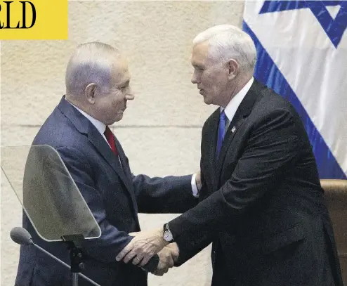  ?? ARIEL SCHALIT / AFP / GETTY IMAGES ?? U.S. Vice President Mike Pence, right, shakes hands with Israeli Prime Minister Benjamin Netanyahu at the Knesset in Jerusalem on Monday. The visit is the final leg of a trip that has included talks in Egypt and Jordan.