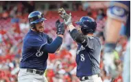  ??  ?? The Brewers’ Travis Shaw (left) celebrates with Ryan Braun after hitting a three-run homer on Tuesday.