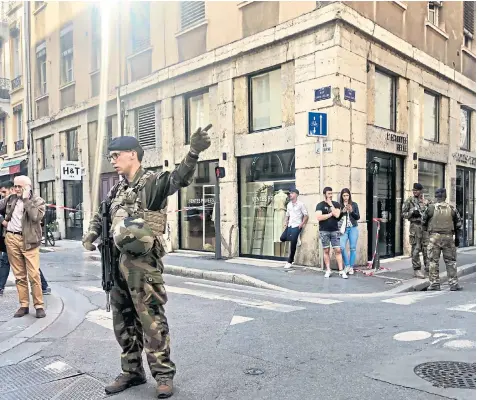  ??  ?? Soldiers from the French anti-terrorist Vigipirate unit secure streets in Lyon close to the site of the explosion that left a dozen people injured yesterday