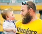  ??  ?? Above:
Steelers linebacker Sean Spence, left, and cornerback William Gay watch Austin Pieniazek, 6, do his touchdown celebratio­n. Austin came with his father, Michael Pieniazek, 33, of State College, who served with the Army in Iraq.