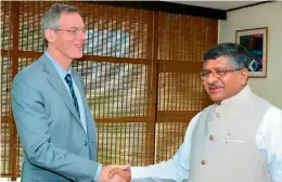  ?? — DC ?? Union minister of electronic & IT and law Ravi Shankar Prasad shakes hands with Qualcomm’s executive chairman Paul Jacobs during a meeting on Monday