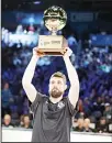  ??  ?? Brooklyn Nets’ Joe Harris holds the champion trophy after winning the NBA All-Star 3-Point contest on Feb 16, in Charlotte, North Carolina. (AP)
