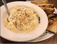  ?? Arkansas Democrat-Gazette/JENNIFER CHRISTMAN ?? The Seafood Fondeaux appetizer comes with garlic bread at Saltgrass Steak House.