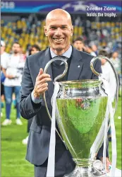  ??  ?? Zinedine Zidane holds the trophy.
