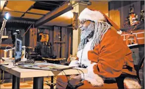  ?? STACEY WESCOTT/CHICAGO TRIBUNE ?? Dreezy Claus, aka Chicago’s Black Santa, visits virtually with 5-year-old Jaden on Dec. 5 from his basement in Chicago. Andre Russell has been doing a mix of visits this year, mostly online.