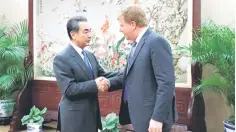  ??  ?? Chinese State Councilor and Foreign Minister Wang Yi shakes hands with Myron Brilliant, executive vice president and head of Internatio­nal Affairs at the US Chamber of Commerce, ahead of a meeting at the Ministry of Foreign Affairs in Beijing, China. — Reuters photo