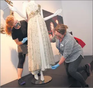  ?? Picture: PAUL CARRACHER ?? BEHIND THE SEAMS: Horsham Regional Art Gallery launched its latest exhibit, The Dressmaker, on Friday. Installer Adelle Rohrsheim, left, and collection­s officer Astrid Barry put the finishing touches on the showcase, featuring costumes from the movie. People will be able to view a diverse range of elegant vintage fashions by award-winning costume designer and exhibition curator Marion Boyce, worn by Hollywood star Kate Winslet and Aussie acting talent Judy Davis, Liam Hemsworth and Hugo Weaving, until January 16.