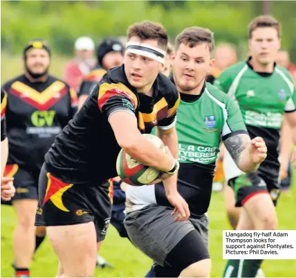  ??  ?? Llangadog fly-half Adam Thompson looks for support against Pontyates. Pictures: Phil Davies.
