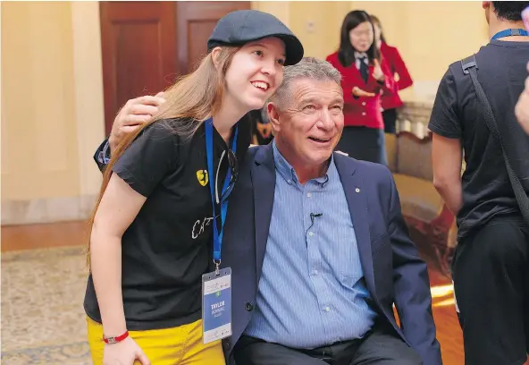  ??  ?? Rick Hansen brought a group of youngsters gathered by his foundation for a leadership conference in Ottawa to a ceremony at the Canadian Museum of History Monday, where a glove he wore during his Man in Motion tour will be permanentl­y housed.