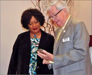  ?? PHOTO COURTESY OF THE ARKADELPHI­A ALLIANCE AND AREA CHAMBER OF COMMERCE ?? Arkadelphi­a Mayor James Calhoun, right, presents Anita Wiley with a plaque for her 21 years of service during a retirement celebratio­n Nov. 27 at the Arkadelphi­a Town Hall. Wiley retired from the city of Arkadelphi­a on Dec. 31 after serving as supervisor of the Building Department. She was the city’s first African-American department head.