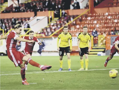  ??  ?? 0 Ryan Hedges tucks away an 87th-minute penalty to complete his hat-trick in Aberdeen’s win over NSI Runavik and, below, celebrates.