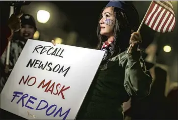  ?? Robert Gauthier Los Angeles Times ?? A PROTEST against pandemic restrictio­ns in Huntington Beach in November. Coronaviru­s restrictio­ns imposed by Gov. Gavin Newsom, including a mask mandate, helped inspire a recall campaign against him.