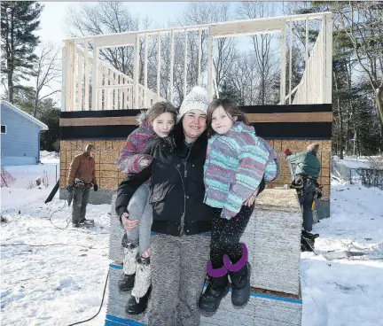  ?? TONY CALDWELL ?? Karalee Shaw Plourde and her daughters Kiersten and Kaylee in front of their new house in Constance Bay. The family were victims of the flooding last spring and are grateful for the work that the Mennonite Disaster Service has provided to rebuild their...