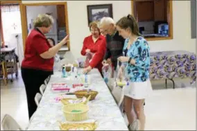  ?? SUBMITTED PHOTO ?? Pastor Peg Ward, left, provides direction to volunteers from the Three Voices on how to assemble hygiene kits for local veteran agencies.