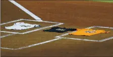  ?? PHOTO BY BOB LEVEY — GETTY IMAGES ?? The A’s and Astros left No. 42 jerseys in the batter’s boxes and a Black Lives Matter T-shirt on home plate before walking off the field Friday.