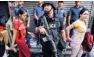  ?? - Reuters file photo ?? WAR ON DRUGS: A policeman holds his weapon as people pass by during a drug raid in Quezon City, Metro Manila, Philippine­s, October 12, 2016.