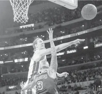  ?? RINGO H.W. CHIU/AP ?? Kelly Olynyk blocks Isaiah Thomas’ shot during Friday’s game. Olynyk scored 17 points off the bench in the Heat’s win.