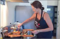  ?? NEWS PHOTO MO CRANKER ?? Christine Bridgman cooks some chili Friday in an apartment downtown. She will be serving up Australian-inspired chili during the Chili Cookoff Saturday. The event runs all day Saturday starting at noon.