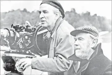  ?? Photograph­s from Embassy Pictures ?? INGMAR BERGMAN, left, works with cinematogr­apher Sven Nykvis on “Fanny and Alexander” in 1982.