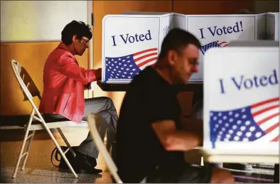  ?? Tyler Sizemore/Hearst Connecticu­t Media ?? Stamford resident Linda Swan, left, casts her ballot at the District 7 polling center at First Presbyteri­an Church in Stamford on Election Day, Tuesday, Nov. 8.