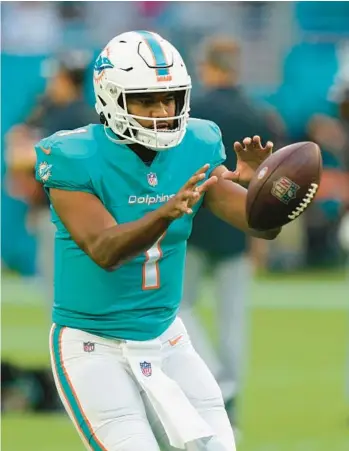  ?? WILFREDO LEE/AP ?? Dolphins quarterbac­k Tua Tagovailoa warms up before the start of a preseason game against the Raiders on Aug. 20 in Miami Gardens.