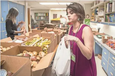  ?? NICK OZA/THE REPUBLIC ?? Teachers Elizabeth Meadows (front) and Adriana Brown assemble student lunches Tuesday at Kino Junior High School. Some low-income students may miss out on meals if Thursday’s planned walkout goes forward.