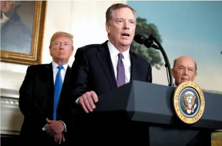  ?? CITIZEN NEWS SERVICE PHOTO ?? U.S. President Donald Trump, left, and Secretary of Commerce Wilbur Ross, right, listen to United States Trade Representa­tive Robert Lighthizer speak during an event to announce tariffs and investment restrictio­ns on China, in the Diplomatic Reception Room of the White House on Thursday, March 22 in Washington.