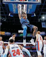  ?? [PHOTO BY ?? Oklahoma City’s Jerami Grant, center, dunks the ball during Friday night’s game against Detroit at Chesapeake Energy Arena. The Pistons won the game, 99-98.