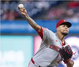  ?? CHRIS SZAGOLA / AP ?? Reds starting pitcher Frankie Montas delivers during the first inning against the Phillies on April 3 in Philadelph­ia. MLB pitch clock violations dropped to an average of 0.34 per game in this season’s first two weeks from 0.84 last season.