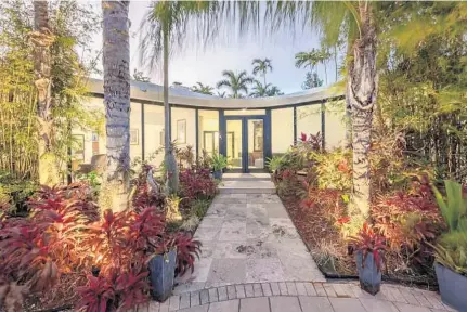  ?? DOUGLAS ELLIMAN REAL ESTATE/COURTESY PHOTOS ?? This 4,842-square-foot gated property, which was built in 1952, has four bedrooms and 4
baths and includes 100 feet of water frontage.