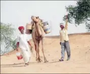  ?? HT FILE PHOTO ?? Drought-affected villagers fetch water on camel back in western Rajasthan.