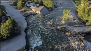  ?? DAVID GOLDMAN — THE ASSOCIATED PRESS ?? A house sits in Rock Creek on Wednesday after floodwater­s washed away a road and a bridge in Red Lodge, Mont. Part of Yellowston­e National Park is likely to remain closed for the rest of the summer.