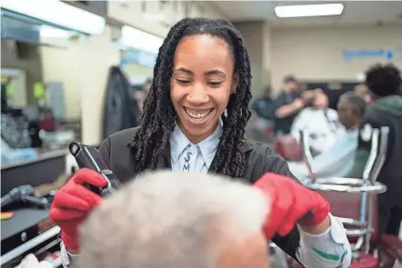  ?? COURTNEY HERGESHEIM­ER/COLUMBUS DISPATCH ?? Jasmine Craig, 27, a student at the Ohio State College of Barber Styling in Whitehall, talks to Frank Rollins, 75, of Jefferson Township, about how he wants his hair cut. Students hone their skills by practicing on clients from the community at discounted rates.