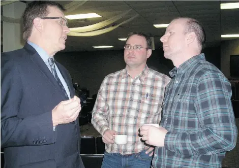  ?? Sheila Prat t/edmonton Journal ?? Lawyer Keith Wilson, left, talks with clients Alain and Brian Labrecque, right, at the public hearing in Peace River