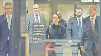  ?? — AFP file photo ?? Photo shows Meng (centre) a er a short morning session that ended the fourth day of trial in her extraditio­n case, leaves British Columbia Supreme Court with her security detail in Vancouver, British Columbia.