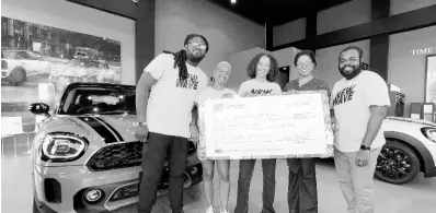  ?? CONTRIBUTE­D ?? The New Wave team hands over a symbolic cheque totalling $650,000 to the Alpha School of Music at the MINI Jamaica Showroom where the fifth staging of Celebrity Closet was held. From left: Yannick Reid, director of New Wave parent company, Very Culture; Lindsey Lodenquai, director, New Wave; Alysia Francis, director, Very Culture; Gay Magnus, bandmaster, Alpha School of Music, and Travis-john Bailey, director, Very Culture.