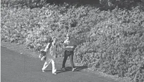  ?? ROB SCHUMACHER/USA TODAY SPORTS ?? Billy Horschel walks to the sixth green as azaleas bloom on the hillside during a practice round at Augusta National.