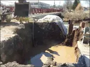  ?? EVAN BRANDT — MEDIANEWS GROUP ?? Water is still oozing from the broken water main and into Manatawny Creek where a series of booms has been set up to try to capture the sediment.